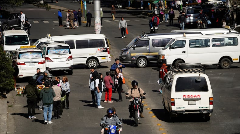 People walk during strike by the public transportation sector in La Paz, Bolivia, Friday, Dec. 19, 2025, after President Rodrigo Paz announced the end of fuel subsidies. (AP Photo/Freddy Barragan)