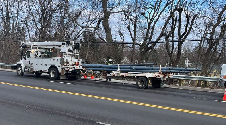 Crews work to remove the poles for the Greater Dayton Regional Transit Authority trolley buses on Far Hills Avenue, just north of Patterson Road, on Monday, Dec. 30, 2024, in Oakwood. JEN BALDUF/STAFF