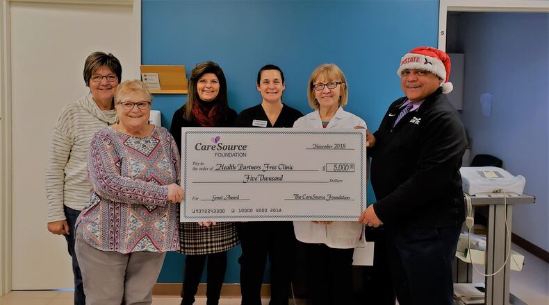 Ellen Mayer (front row, left) was a huge advocate for Health Partners in Miami County and many other organizations. She is shown here in a holiday time 2018 presentation of a check for the Miami County organization. Contributed
