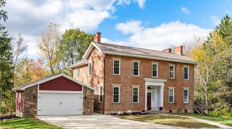 This brick antebellum style farmhouse was built in 1846 and has been updated with new bathrooms, HVAC and roof. It sits on 48 wooded acres in Xenia. CONTRIBUTED