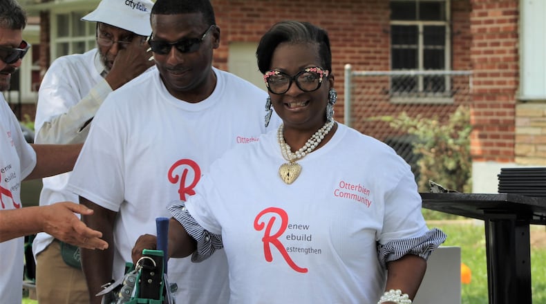 Tena Dunson holds a donated bag of tools and supplies as part of Saturday’s graduation for an electrical program. Dexter McGhee, the instructor and owner of McGhee Electric LLC in Trotwood, helped pass out the certificates. CORNELIUS FROLIK / STAFF
