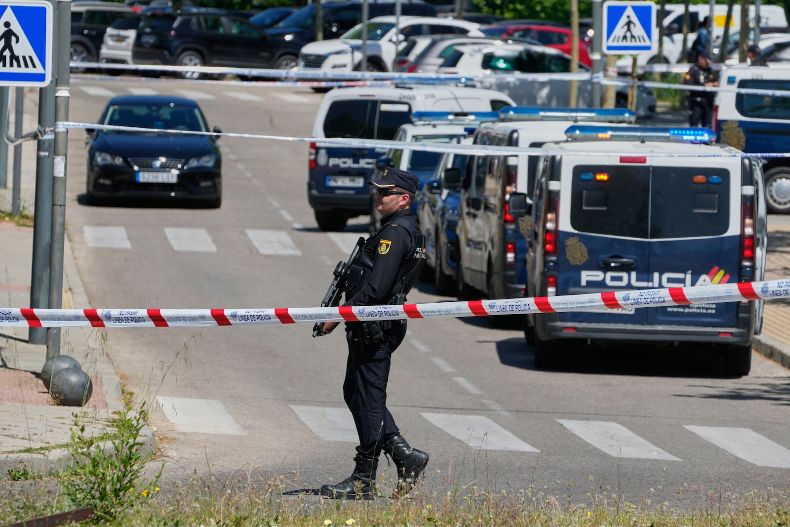 Police officers cordon off the area after an adviser to former Ukrainian president Viktor Yanukovych was shot, outside a school in Madrid, Spain, Wednesday, May 21, 2025. (AP Photo/Paul White)
