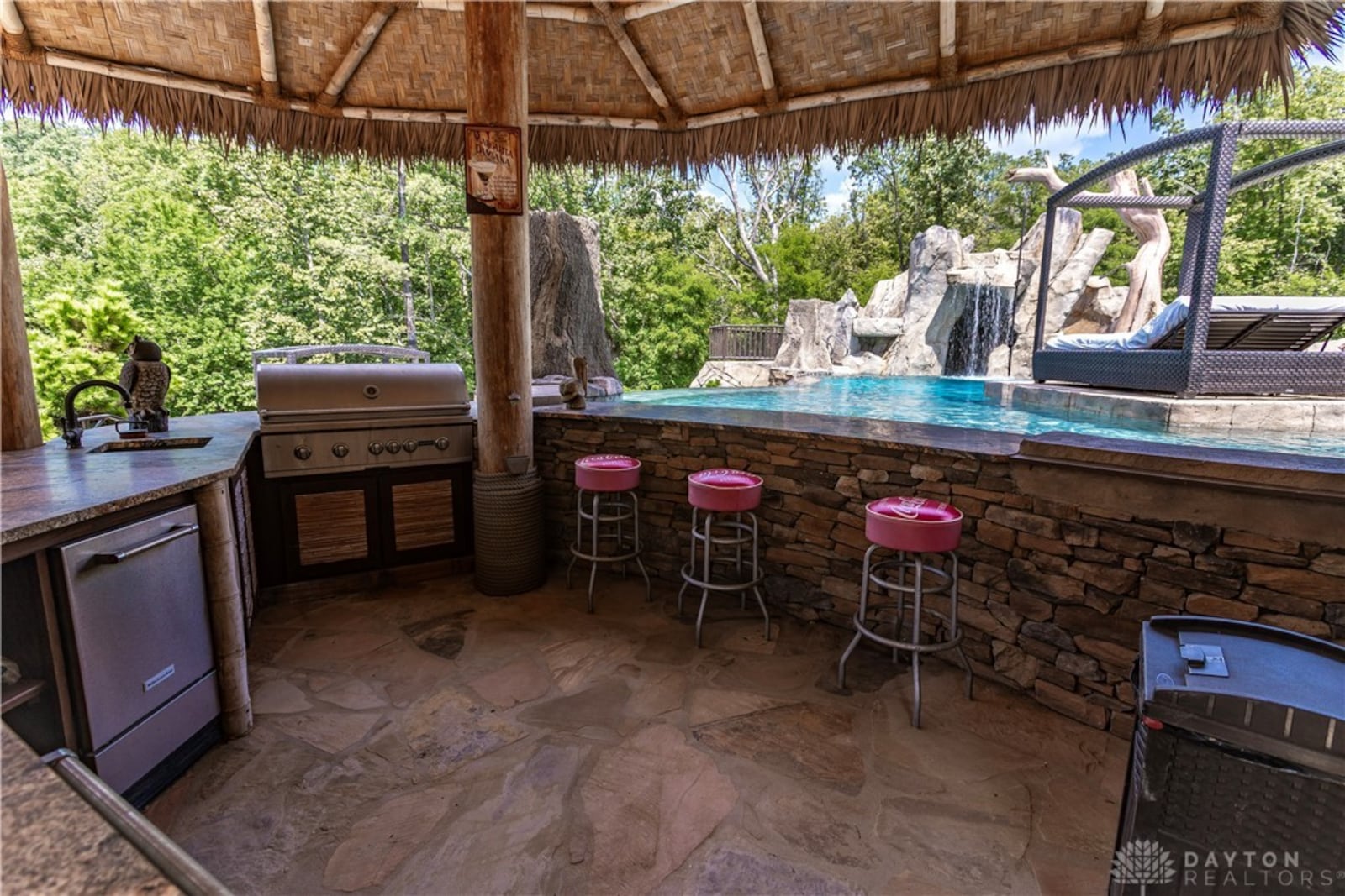 The backyard has a resort like feel with an inground infinity edge pool, outdoor kitchen and tiki bar. CONTRIBUTED