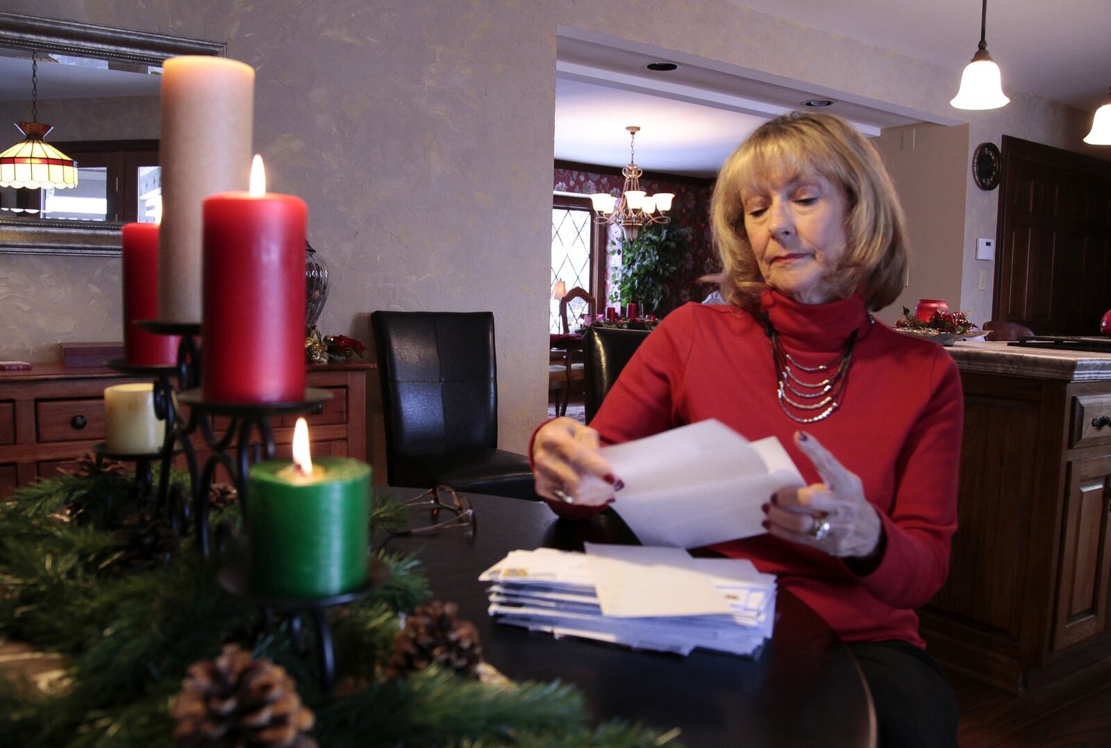 Ohio elector Judy Westbrock looks over a stack of letters asking her to vote against President-elect Donald Trump. Westbrock of Centerville said her vote will stay with Trump today as she casts one of Ohio’s 18 Electoral College votes. BYRON STIRSMAN / STAFF