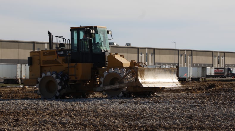 Construction crews work at the site of an estimated $31 million facility near the Dayton International Airport. CORNELIUS FROLIK / STAFF
