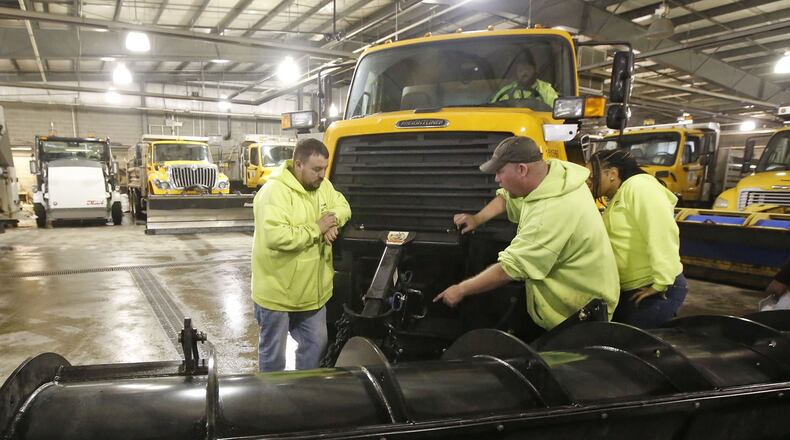 City of Dayton workers prepared their trucks on Thursday for the winter storm that is expected to start as rain and freezing rain on Friday and turn into snow overnight into Saturday. TY GREENLEES / STAFF