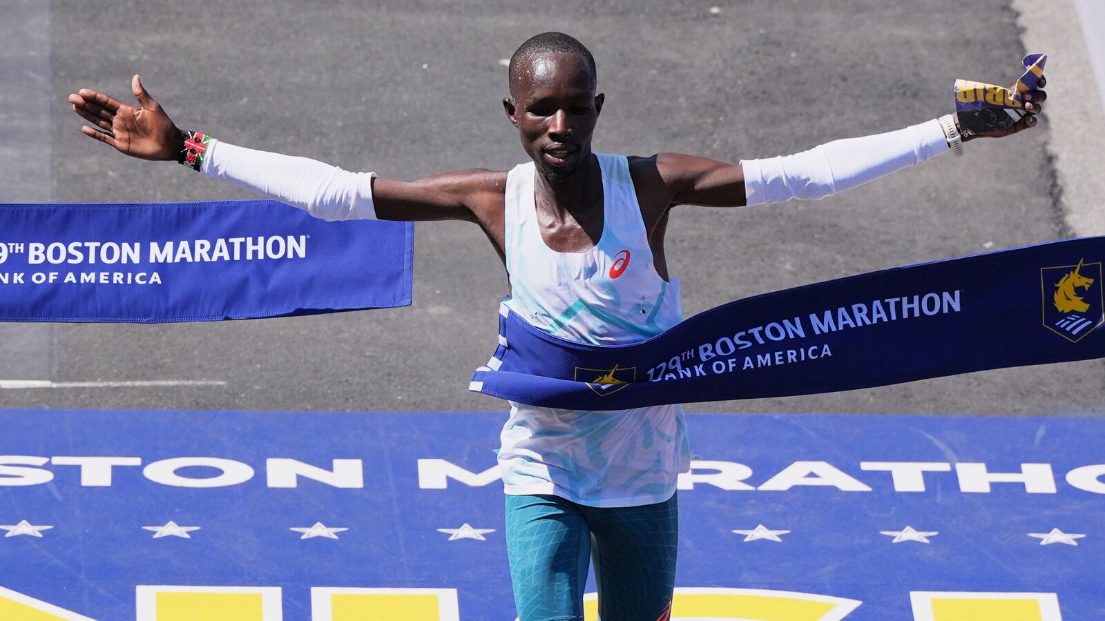 John Korir, of Kenya, breaks the tape to win the Boston Marathon, Monday, April 21, 2025, in Boston. (AP Photo/Charles Krupa)
