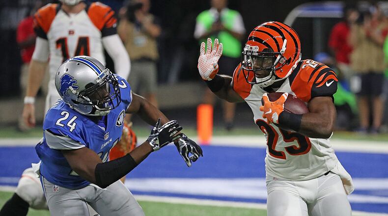 DETROIT, MI - AUGUST 18: Giovani Bernard #25 of the Cincinnati Bengals runs for a short gain as Nevin Lawson #24 of the Detroit Lions attempts to make the stop during the second quarter of the preseason game at Ford Field on August 18, 2016 in Detroit, Michigan. (Photo by Leon Halip/Getty Images)