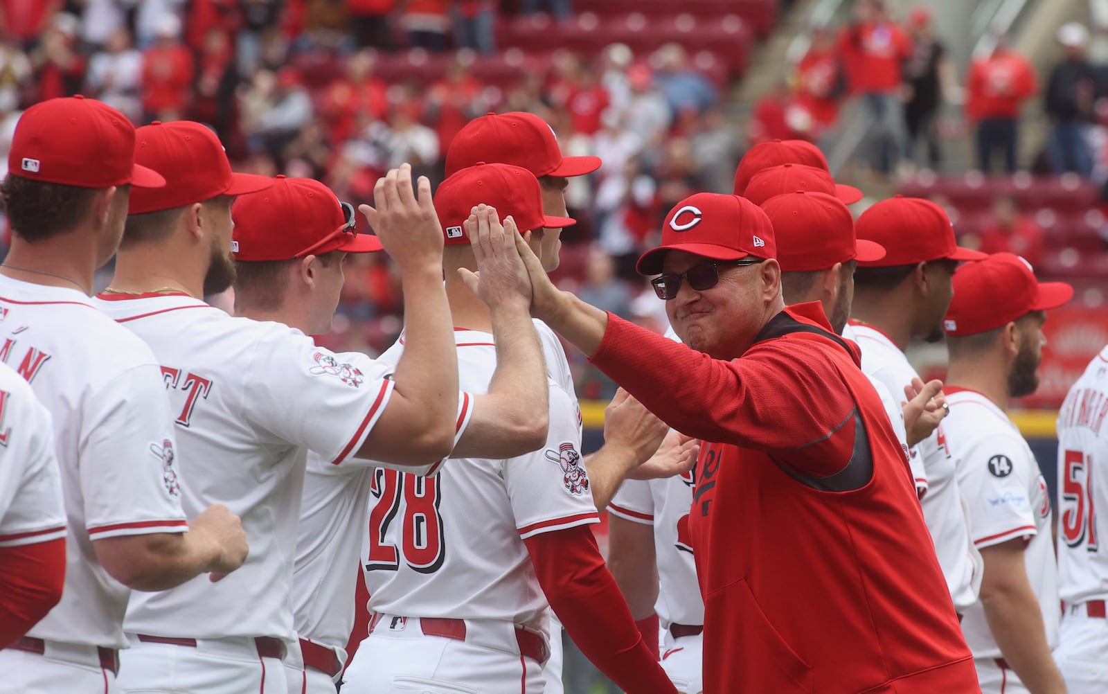 Reds manager Terry Francona slaps hands with players during pregame introductions on Opening Day at Great American Ball Park on Thursday, March 27, 2025, before a game against the Giants at Great American Ball Park in Cincinnati. David Jablonski/Staff
