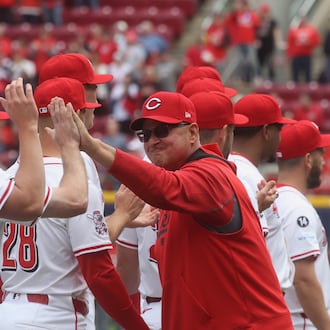 Reds manager Terry Francona slaps hands with players during pregame introductions on Opening Day at Great American Ball Park on Thursday, March 27, 2025, before a game against the Giants at Great American Ball Park in Cincinnati. David Jablonski/Staff