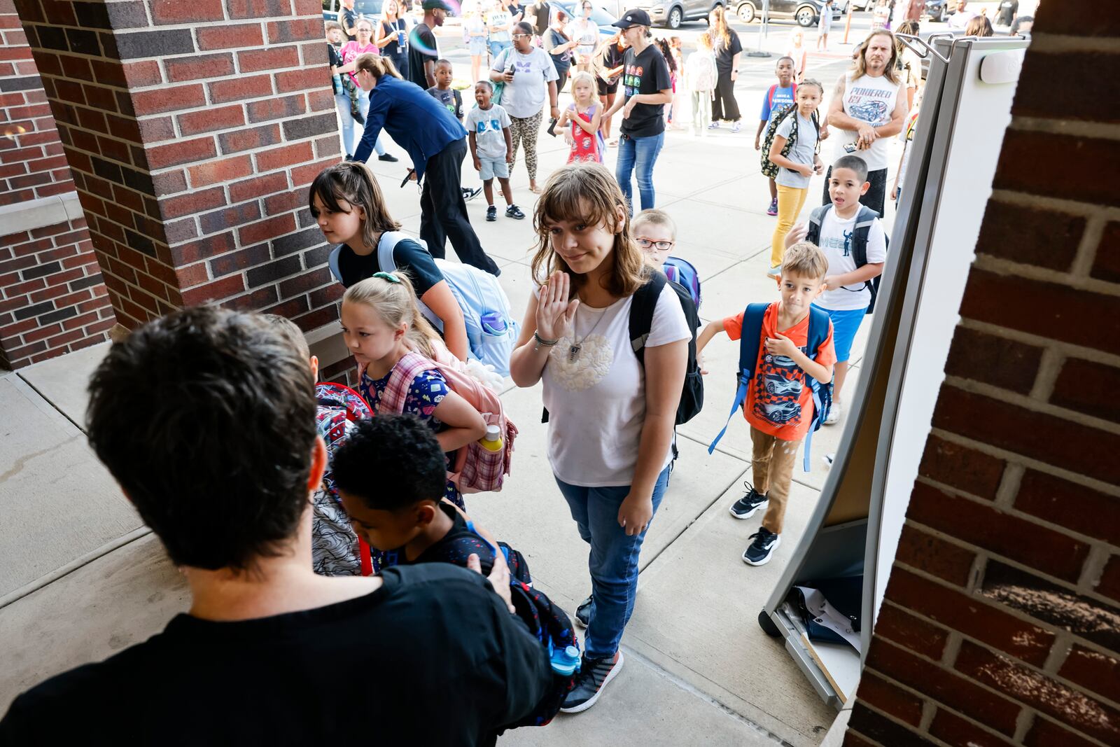 Principal Charity Goode greets students on the first day at Rosa Parks Elementary School Monday, Aug. 18, 2025 in Middletown. NICK GRAHAM/STAFF