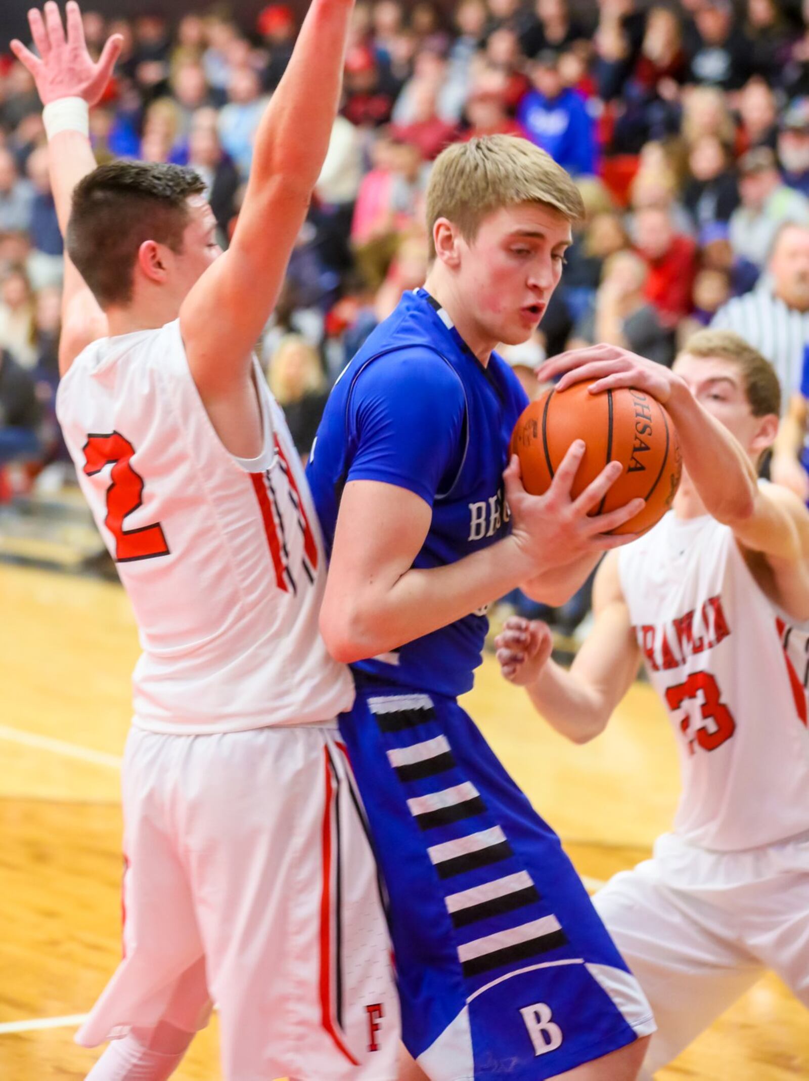 Brookville forward Dominick Pistone (33) is surrounded by Franklin’s Payton Knott (2) and Jared Kinzer (23) during Tuesday night’s game at Darrell Hedric Gymnasium in Franklin. GREG LYNCH/STAFF