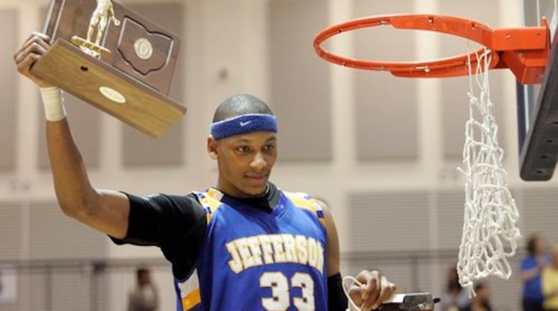 Jefferson's Adreian Payne holds the Regional championship trophy after snipping the net following the game at Trent Arena against Ft. Recovery March, 19, 2010.