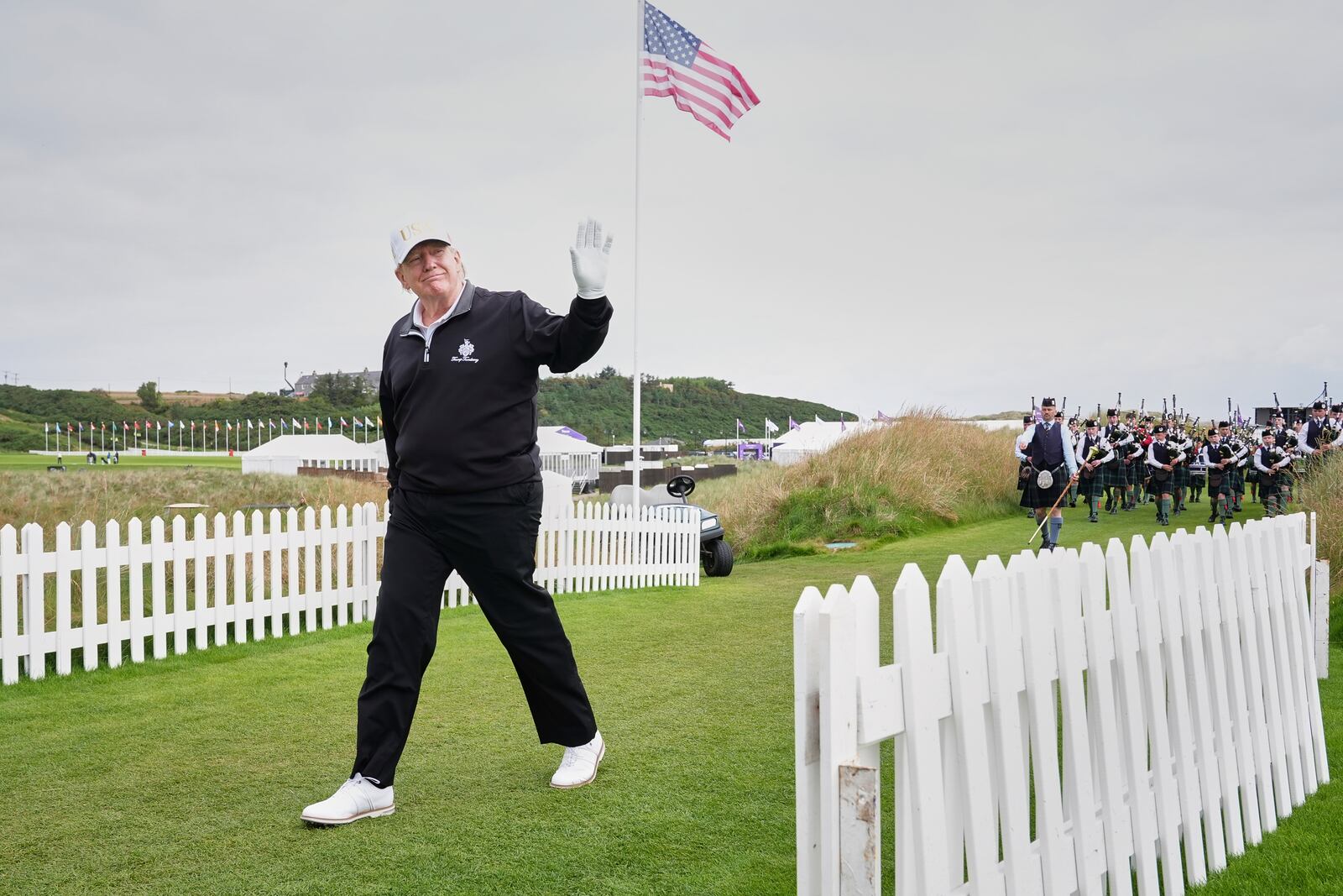 President Donald Trump arrives, followed by a bagpiper band, at the opening ceremony for the Trump International Golf Links golf course, near Aberdeen, Scotland, Tuesday, July 29, 2025. (AP Photo/Jacquelyn Martin)