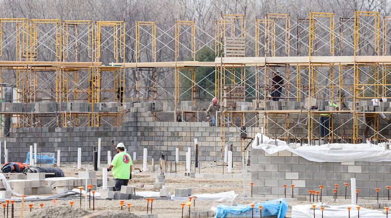 Construction workers work on the site of the future Fairborn Middle School on Thursday, Feb. 19. The school, which is being constructed next to Fairborn High School on Commerce Center Boulevard, is planned to open in the summer of 2027. BRYANT BILLING / STAFF