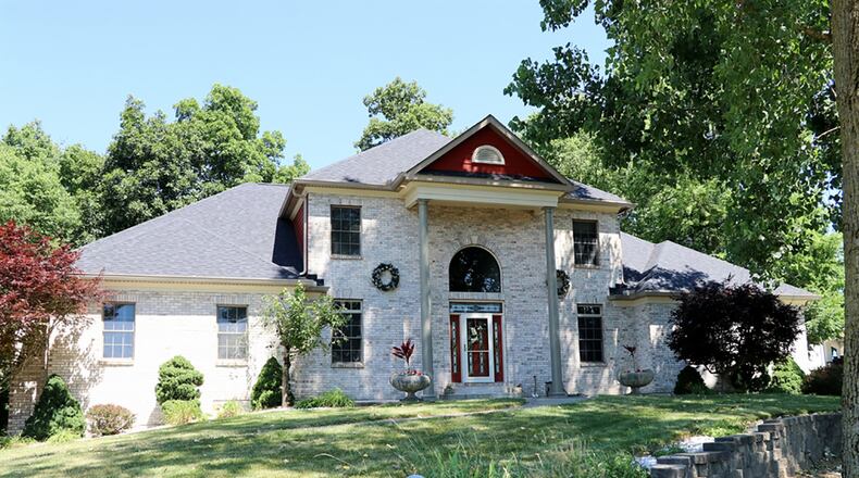 The brick 2-story has about 3,430 sq. ft. of living space, plus a full, finished basement. On just over an acre, the property includes a storage barn, fenced dog run, two wooden rear decks and an oversized, 3-car garage with extra parking pad. CONTRIBUTED PHOTO BY KATHY TYLER