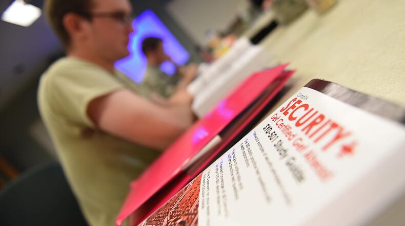 A Security Plus textbook is displayed on a table after the 501 Sec+ ribbon-cutting ceremony at Keesler Air Force Base, Miss., May 24, 2018. The 336th Training Squadron spearheaded a team of 23 individuals over the span of almost 18 months to complete the transition from the 401 Sec+ course to the new 501 course material. (U.S. Air Force photo/Senior Airman Holly Mansfield)