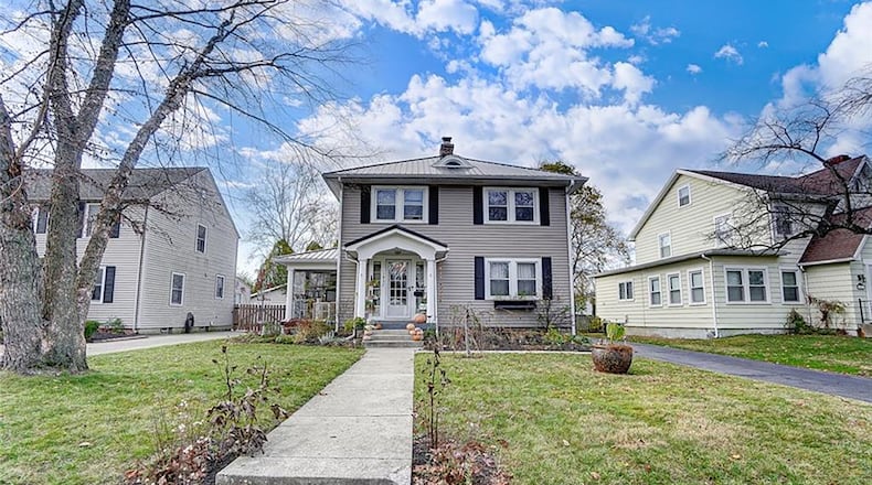 The front features a concrete walk from the sidewalk and an asphalt driveway leading to the detached garage. The front porch is covered and both house and garage have new metal roofs. Contributed photos