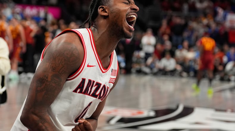 Arizona's Jaden Bradley celebrates after making the game-winning shot at the buzzer to defeat Iowa State during an NCAA college basketball game in the semifinal round of the Big 12 Conference tournament Friday, March 13, 2026, in Kansas City, Mo. (AP Photo/Charlie Riedel)