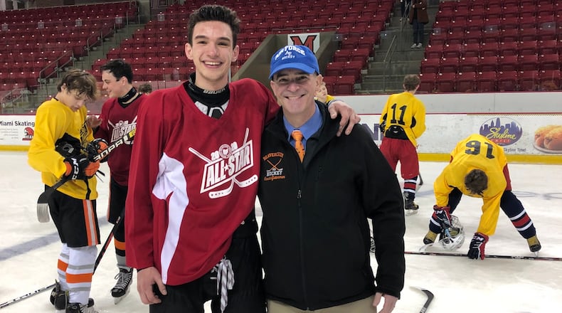 Gutterman (right) with his son Cole at the Southwest Ohio High School League All Star game, sponsored by the Academy Hockey Club.