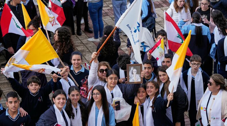 People wait for the arrival of Pope Leo XIV at the De la Croix hospital in Jal el Dib, Lebanon, Tuesday, Dec. 2, 2025. (AP Photo/Hassan Ammar)