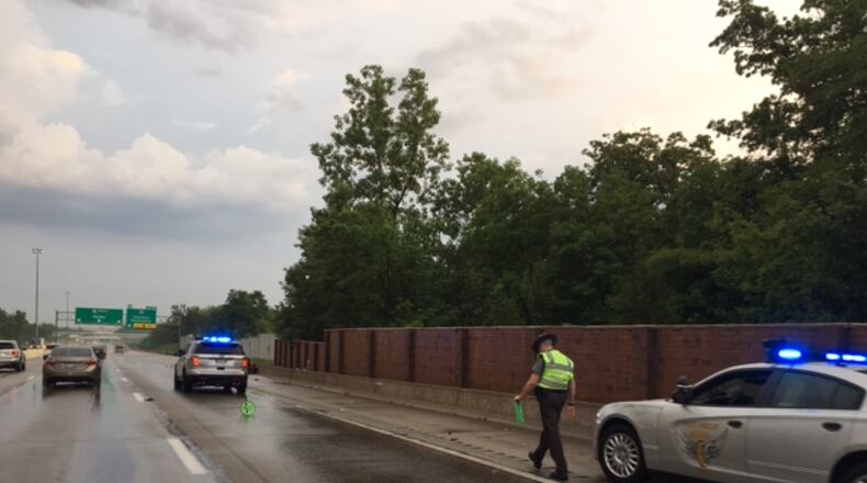 Ohio State Highway Patrol troopers from the Dayton Post investigate a single-vehicle crash Sunday evening, June 4, 2017, in which a car landed on its top on southbound Interstate 75 in Vandalia. MAX FILBY / STAFF