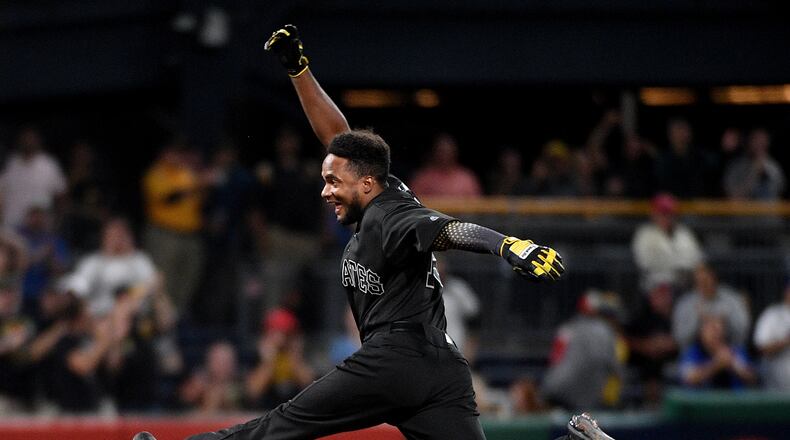 PITTSBURGH, PA - AUGUST 23: Pablo Reyes #15 of the Pittsburgh Pirates reacts as he rounds the bases after hitting a walk-off RBI single to left field giving the Pittsburgh Pirates a 3-2 win over the Cincinnati Reds at PNC Park on August 23, 2019 in Pittsburgh, Pennsylvania. Teams are wearing special color schemed uniforms with players choosing nicknames to display for Players' Weekend. (Photo by Justin Berl/Getty Images)