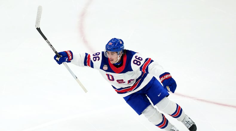 United States' Jack Hughes celebrates after scoring the winning goal against Canada during the overtime period of the men's ice hockey gold medal game at the 2026 Winter Olympics in Milan, Italy, Sunday, Feb. 22, 2026. (AP Photo/Carolyn Kaster)