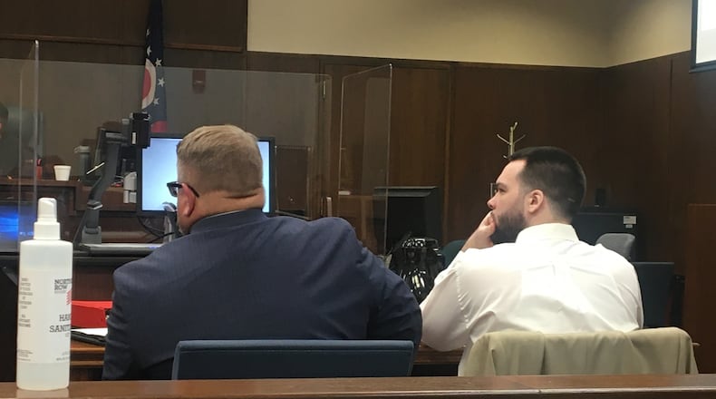 Dylan Dugan, 26, of Trotwood, right, appears with his attorney in Montgomery County Common Pleas Court Monday, July 26, 2021, for the first day of his murder trial in the September 2019 death of Mitchel Miller at a Kettering apartment. PARKER PERRY / STAFF