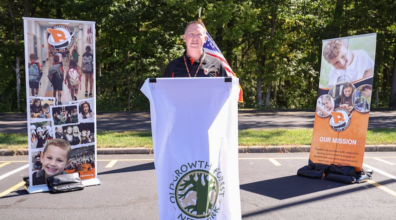 Beavercreek City Schools superintendent Paul Otten speaks during a ceremony on Wednesday, Oct. 1 in the parking lot of Beavercreek High School. The ceremony was in recognition of Ferguson Land Lab being added to Old Growth Forest Network. The forest is located east of the school. BRYANT BILLING / STAFF