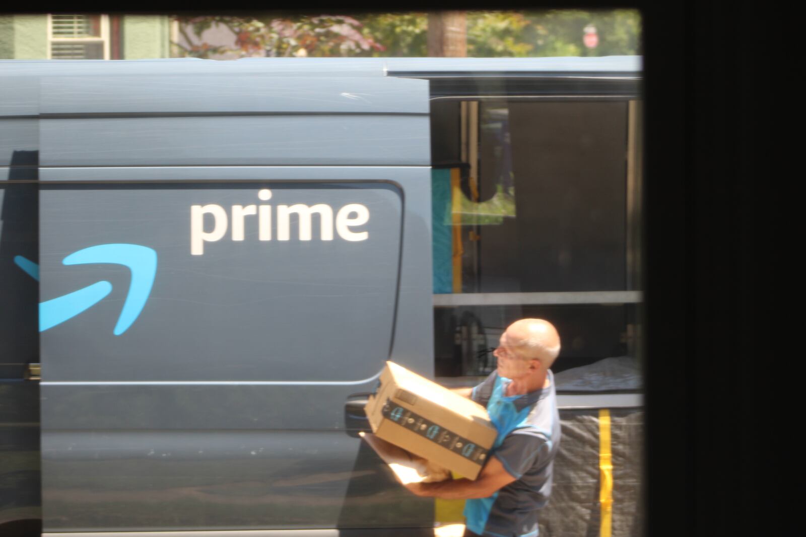 An Amazon delivery driver in Dayton. CORNELIUS FROLIK / STAFF