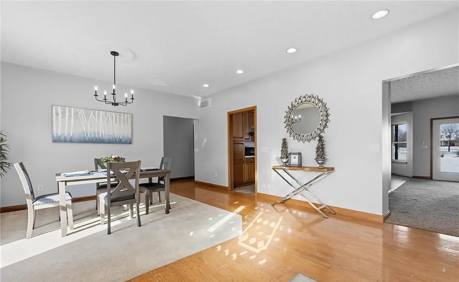 The dining room is open to the foyer and has hardwood flooring, recessed lighting and a decorative chandelier. CONTRIBUTED