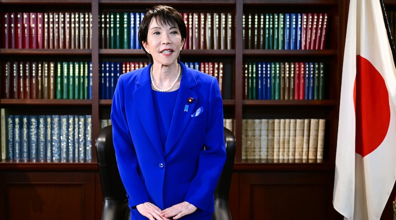 FILE - Sanae Takaichi, the newly-elected leader of Japan's ruling party, the Liberal Democratic Party (LDP), gestures as she leaves the party leader's office after the LDP leadership election in Tokyo, on Oct. 4, 2025. (Yuichi Yamazaki/Pool Photo via AP, File)