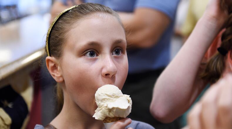 Abbie Vaughan, 11, eats an ice cream cone at Graeter’s Ice Cream in Oxford. NICK GRAHAM/STAFF