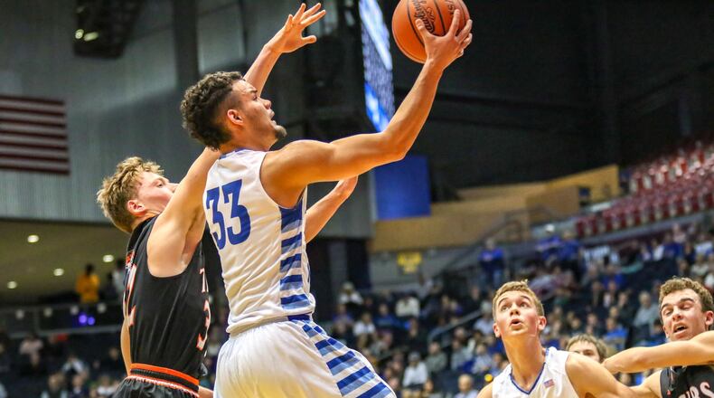 Franklin Monroe’s Ethan Conley drives to the hoop against Jackson Center’s Aiden Reichert during their Division IV district final game on Friday night at University of Dayton Arena. The Tigers won 56-47. CONTRIBUTED PHOTO BY MICHAEL COOPER