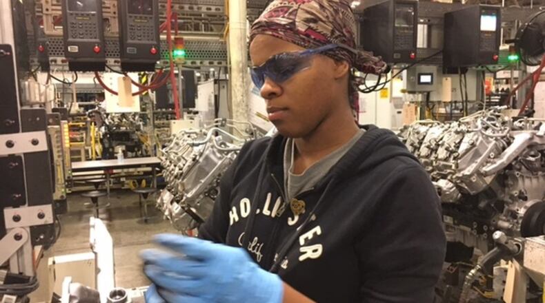 DMAX worker Stephanie Flowers helps assemble the Duramax diesel heavy-duty truck engine — the product of the DMAX plant. THOMAS GNAU/STAFF