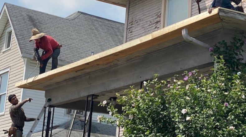 In this 2021 file photo, nonprofits Habitat for Humanity of Greater Dayton and Neighborhood Housing Partnership of Springfield joined forces to provide a new roof for a Springfield senior citizen. CONTRIBUTED PHOTO