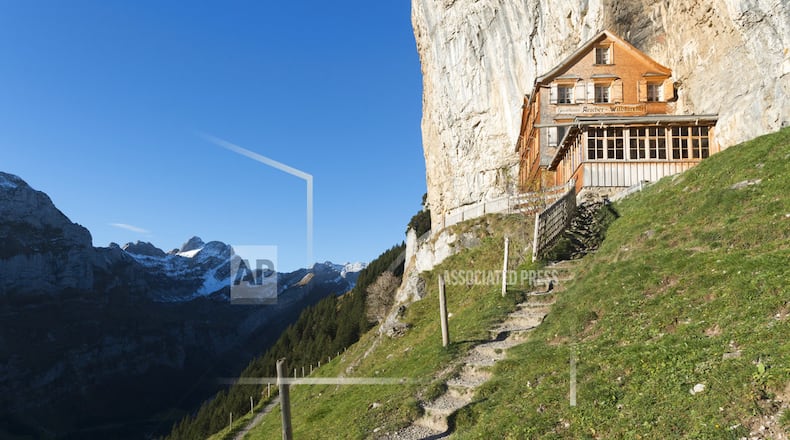 FILE - The Oct. 27, 2015 file photo shows a view of the Aescher mountain hut in Weissbad, Switzerland. The Gasthaus Aescher, built into a cliff above a valley in northeastern Switzerland, has been run by the same family since 1987. Authorities in Appenzell-Innerrhoden canton said Monday, Aug. 20, 2018 that the current tenants, Nicole and Bernhard Knechtle-Fritsche, are giving up the lease at the end of the 2018 season. (Gian Ehrenzeller/Keystone via AP)