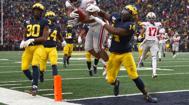 ANN ARBOR, MICHIGAN - NOVEMBER 30: J.K. Dobbins #2 of the Ohio State Buckeyes dives for a fourth quarter touchdown past Josh Metellus #14 of the Michigan Wolverines at Michigan Stadium on November 30, 2019 in Ann Arbor, Michigan. (Photo by Gregory Shamus/Getty Images)