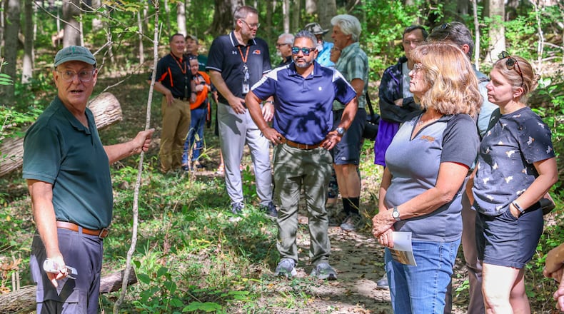Dave Nolin (left) talks while leading a tour on Wednesday, Oct. 1, of Ferguson Land Lab, which has been added to Old-Growth Forest Network. The forest, which is located next to Beavercreek High School, is the first in Greene County to earn such a designation. Nolin is a retired Five Rivers MetroPark conservation director who researched the history of the forest. BRYANT BILLING / STAFF