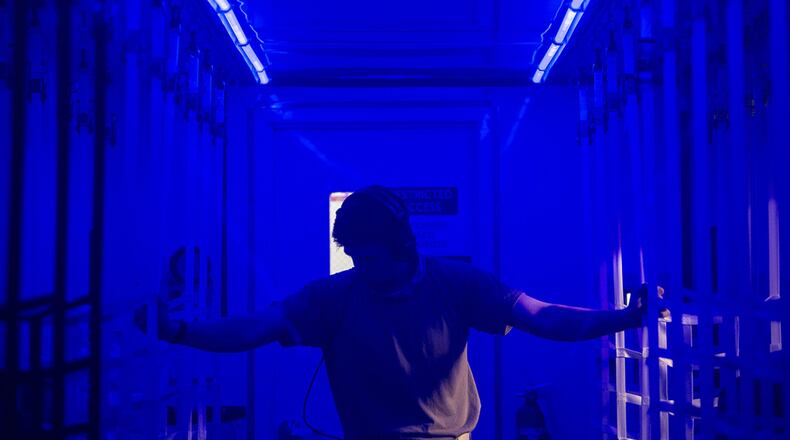 Capt. Conor Favo, 28th Test and Evaluation Squadron division chief, walks through a Negatively Pressurized Conex prototype April 30 while conducting in-flight testing on a C-17 Globemaster III. The NPC is designed to transport individuals with the COVID-19 virus and other highly infectious diseases, all while preventing the aircrew and medical professionals onboard from being exposed. (U.S. Air Force photo/Staff Sgt. Chris Drzazgowski)