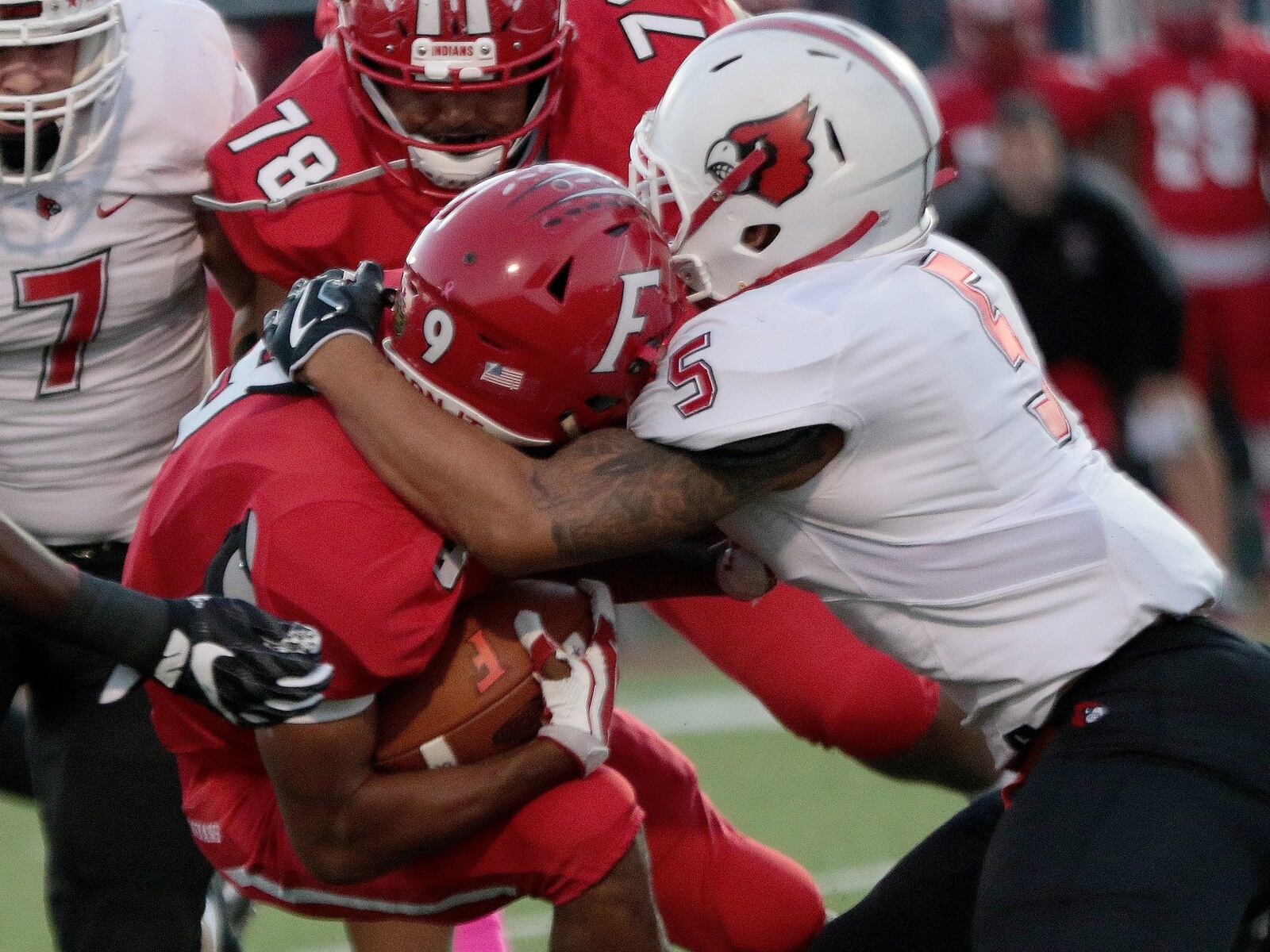 Fairfield’s Jutahn McClain (9) is pulled down by Colerain’s Ivan Pace Jr. during Friday night’s game at Fairfield Stadium. That’s the Indians’ Derrick Benford (78) closing in on the play. CONTRIBUTED PHOTO BY TONY TRIBBLE/WCPO.COM