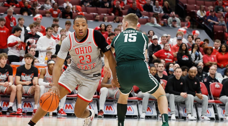 Ohio State's Zed Key, left, drives the baseline past Michigan State's Carson Cooper during the second half of an NCAA college basketball game on Sunday, Feb. 12, 2023, in Columbus, Ohio. (AP Photo/Jay LaPrete)
