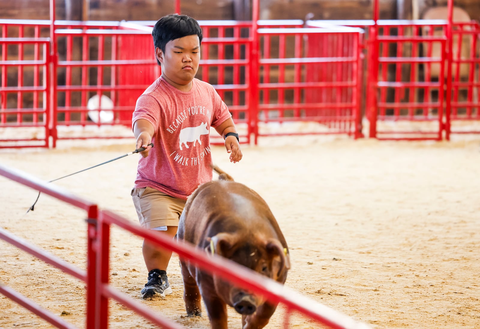 Alex Johnston, from the television show "7 Little Johnstons", learns how to show pigs at the Butler County Fair Monday, July 21, 2025 in Hamilton. Johnston and some of his family had a film crew following them around the fair creating content for the show. NICK GRAHAM/STAFF