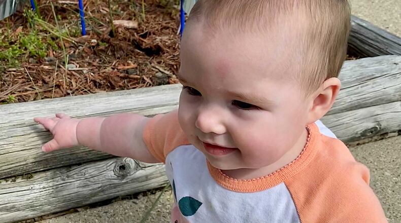 Georgia Rupert eyes the Pinwheel Garden planted in front of Wright-Patterson Air Force Base’s New Horizons Child Development Center on April 27. “Pinwheels for Prevention” is a national campaign aimed at bringing awareness to child abuse. U.S. AIR FORCE PHOTO/SENIOR AIRMAN EMILY RUPERT
