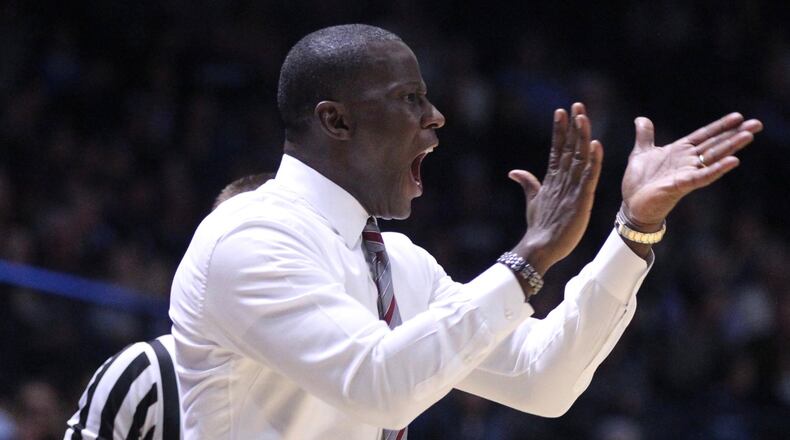 Dayton’s Anthony Grant claps during a game against Rhode Island on Friday, Feb. 23, 2018, at the Ryan Center in Kingston, R.I. David Jablonski/Staff