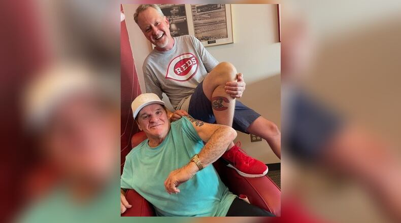 Cincinnati Reds great Pete Rose and Mark Fugate, owner of Sports Gallery, a sports memorabilia store, compare their Reds tattoos. SUBMITTED PHOTO