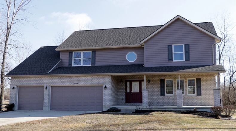 The brick-and-frame Colonial-style 2-story has about 2,505 square feet of living space. The 4-bedroom house sits well off the road at the end of the street. A concrete driveway leads up to the 3-car, attached garage, and a walkway wraps up to the covered front porch. CONTRIBUTED PHOTO BY KATHY TYLER