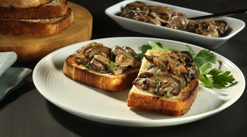 A mix of mushrooms is sauteed with shallots then flavored with sherry and cream to make a rich topping for toast. (Joan Moravek/food styling) (Chris Walker/Chicago Tribune/TNS)