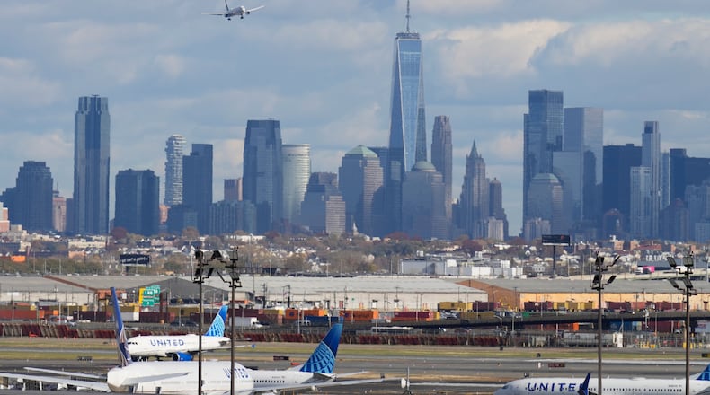FILE - The New York City skyline is seen behind a plane approaching Newark International Airport in Newark, N.J., Nov. 6, 2025. (AP Photo/Seth Wenig, File)